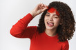 © Cookie Studio - Close-up charming sassy good-looking woman curly dark hairstyle take-off red sunglasses winking cheeky stick out tongue flirting look joyful excited enjoy cool party, white background