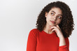 © Cookie Studio - Close-up thouthful unsure hesitant young attractive stylish mixed-race woman curly dark hairstyle look up thinking pondering important decision have hard choice, daydreaming perplexed