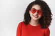 © Cookie Studio - Stylish modern carefree attractive hispanic woman dark curly hairstyle in summer red sunglasses smiling delighted enjoy perfect sunny weather walk standing white background rejoicing good mood