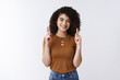 © Cookie Studio - Heading top. Attractive friendly happy charismatic curly-haired girl raise index fingers pointing up smiling cheerful showing chart promoting product, standing white background advertising