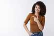 © Cookie Studio - See yourself crazy sale. Cheerful pleasant pretty curly-haired caucasian stylish woman inviting check-out product suggest look left pointing aside index finger grinning delighted, white background