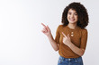 © Cookie Studio - Girl help pick best choice. Cheerful smiling happy glad curly-haired woman brag new furniture pointing upper left corner index fingers aside grinning delighted recommend product copy space