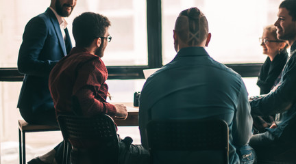 multinational business team brainstorms in the workplace in a mo