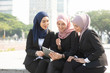 © WONG SZE FEI - Muslim business women discussing