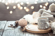 © puhimec - Coffee cup over Christmas lights bokeh in home on wooden table with sweater on a background and decorations. Holiday decoration, magic Christmas