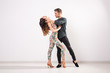 © satura_ - Salsa, kizomba and bachata dancers on white background with copy space. Social dance concept