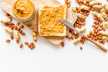 Wall Mural - Make sandwiches with peanut butter in glass bowl on white background top view copyspace