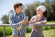 © caftor - country couple of farmers drink milk in field near fenc