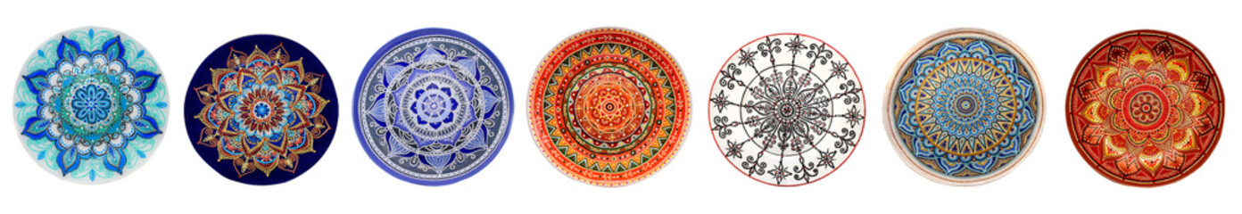 Set of decorative ceramic dishes hand-painted with acrylic paints floral pattern isolated on white background