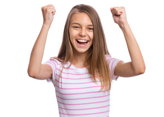 Portrait of successful teen girl winner with raised hands and clenching fists. Beautiful caucasian teenager laughing, isolated on white background. Happy cute child exclaiming with joy and excitement