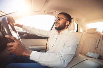 African-american man driving car, going to work