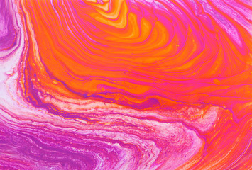 photography of abstract marbleized effect background. red, pink, orange and white creative colors. Beautiful paint.