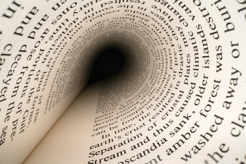 Inside the book concept. Latin letters and words on an tunnel shaped, perspective book page with black dramatic light. Education, knowledge concept