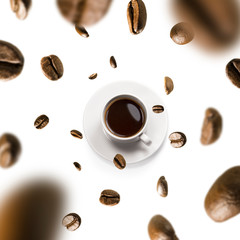 Cup of coffee and coffee beans in flight on white background