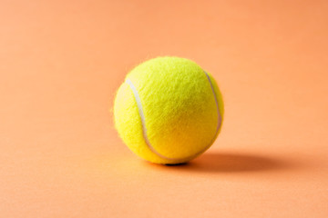 Wall Mural - Tennis ball on orange abstract background