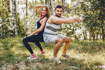 Handsome man in a park. Sportsman in a sportswear. Couple training