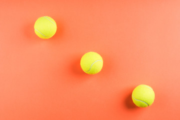 Wall Mural - Three tennis balls on orange. Concept