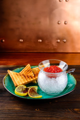 Canvas Print - Upper view on white rectangular plate with different snacks caviar and bread with lemon on a dish