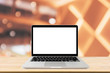© Kwangmoozaa - Blank screen laptop computer on wood table top with blur cafe restaurant with abstract bokeh light defocused background