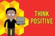 Word writing text Think Positive. Business photo showcasing The tendency to be positive or optimistic in attitude Standing man in suit wearing eyeglasses holding open laptop photo Art