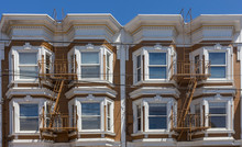 Brown San Francisco Victorian Style Apartment Buildings With Fire Escapes.