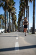 © Gabriel - Beautiful woman in sport clothes running on the bike lane at the seafront in Barcelona (SPAIN)