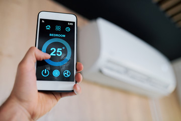 Optimal temperature of air in the room shown on display of smartphone