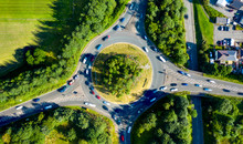 Composite Aerial Image Of Traffic Using A Small Roundabout With Multiple Connecting Roads