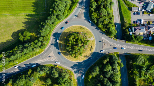 Fotografía Aerial long exposure of traffic on a roundabout in a small town