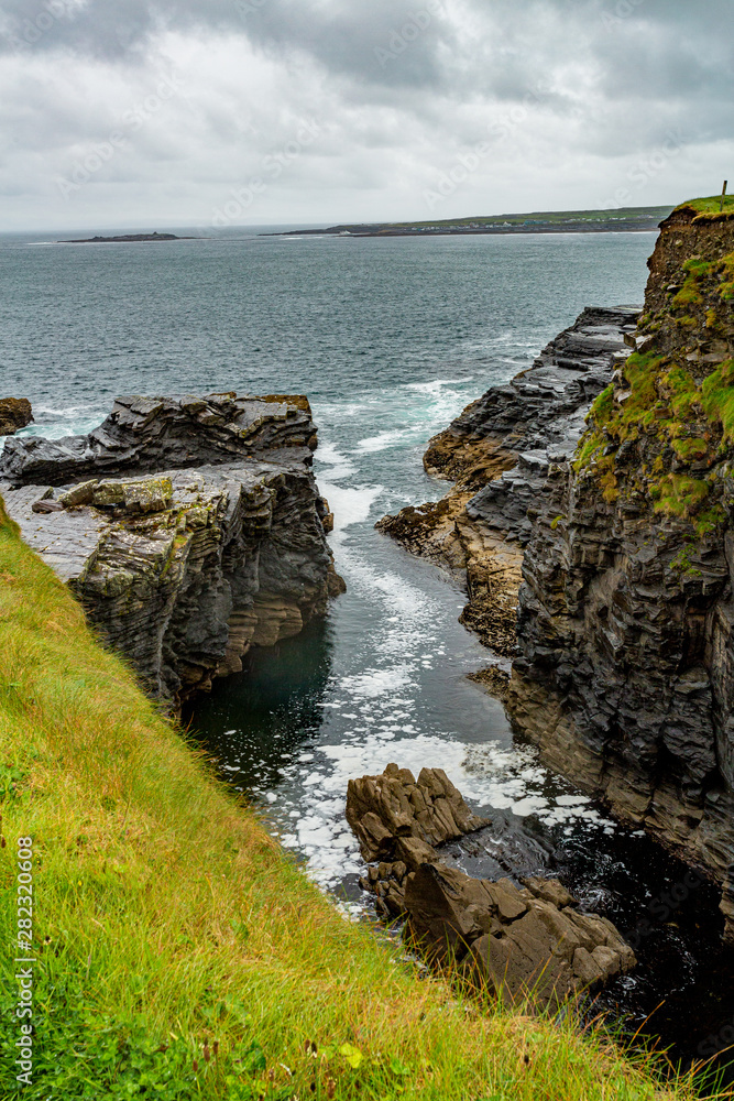 View of the water inlet on a rocky cliff in the coastal walk route from ...