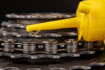 Wall Mural - Oiling the bicycle chain with an oil can on the workshop table. Servicing of bicycle parts.