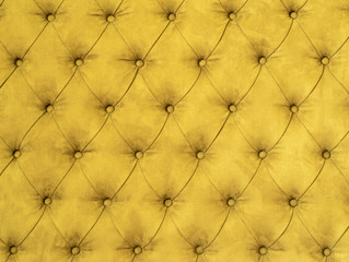 Texture background of upholstered furniture. Yellow colors.