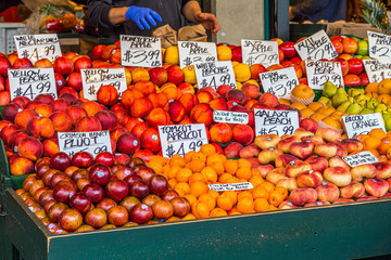 Wall Mural - Hands preparing fruit in an outdoor produce market