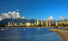 Beautiful Skyline Of Vancouver City At Vancouver Harbor , Harbor, Yacht Near The Beach,  Downtown And Stanley Park On The Background Of A Mountain Range And Blue Cloudy Sky 