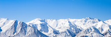 Mountain Peaks Snow Covered Mountain Range With Blue Sky