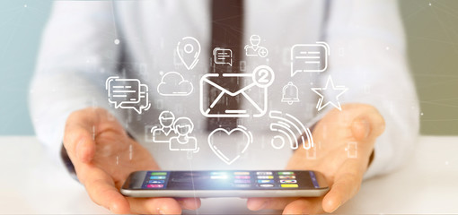 businessman holding a cloud of social media network icon