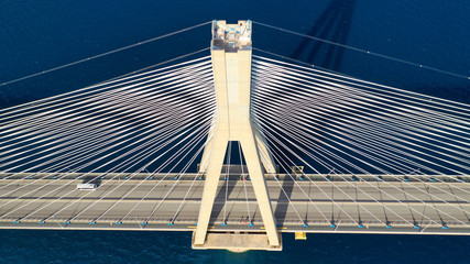 Aerial drone photo of world famous cable suspension bridge of Rio - Antirio Harilaos Trikoupis, crossing Corinthian Gulf, mainland Greece to Peloponnese, Patras