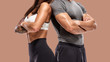 part of Two young athletes posing on brown background