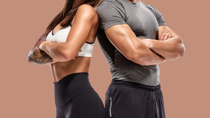 Wall Mural - part of Two young athletes posing on brown background