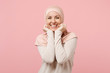 Joyful young arabian muslim woman in hijab light clothes posing isolated on pink background studio portrait. People religious Islam lifestyle concept. Mock up copy space. Keeping hands near cheeks.