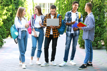 Wall Mural - Portrait of young students outdoors