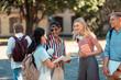 © zinkevych - Group of students joking in the university yard.