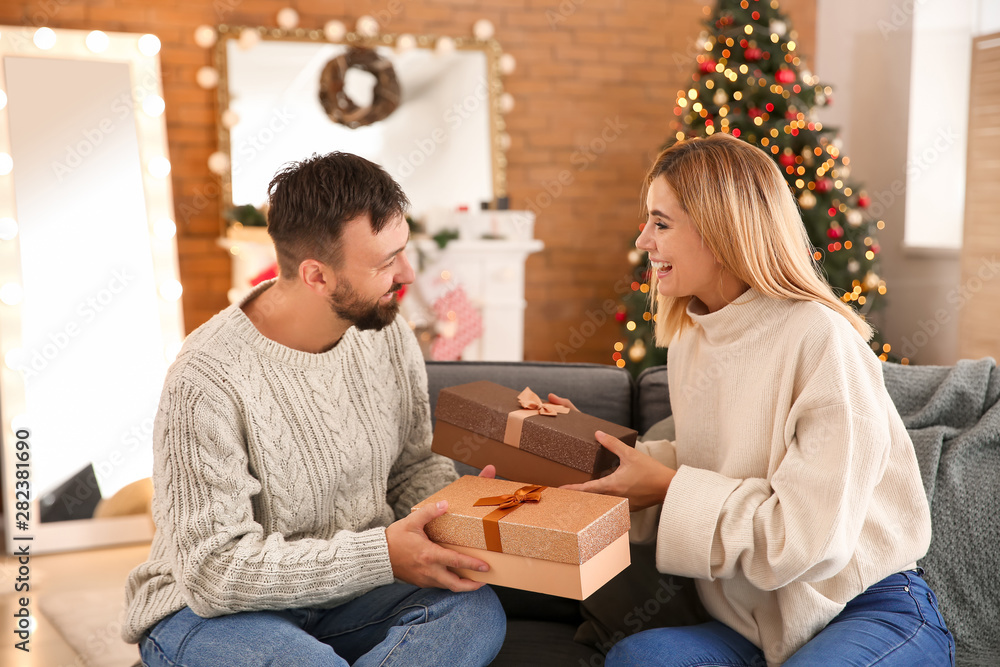 Happy couple greeting each other on Christmas eve