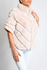 Wall Mural - Womens fur jacket, short sleeve, with a light pink tint.