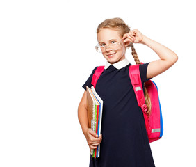 Wall Mural - Cheerful 8 years old schoolgirl with backpack wearing uniform standing isolated over white background. Ready for school