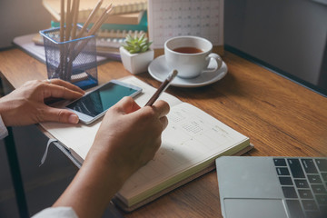 Wall Mural - on 2019 calendar book,female'hand of planner writing daily appointment.woman mark and noted schedule