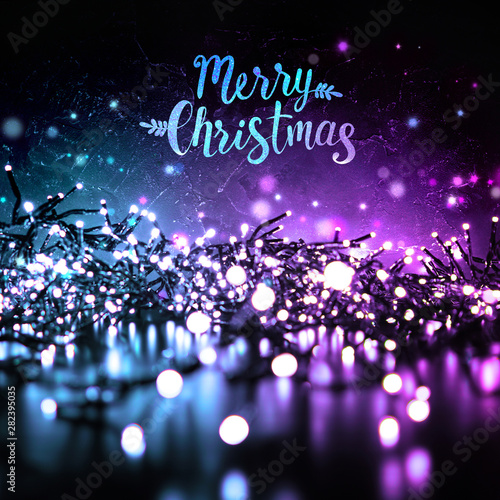 Sparkling Christmas Lights In The Evening At Night On A Dark Background And The Inscription Merry Christmas Blue And Purple Color Buy This Stock Photo And Explore Similar Images At Adobe