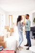 © Monkey Business - Loving Couple Surrounded By Boxes In New Home On Moving Day