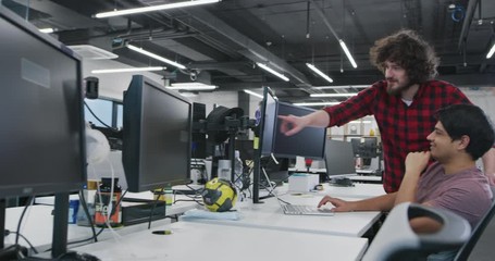Young multiethnic business team of software developers working together using