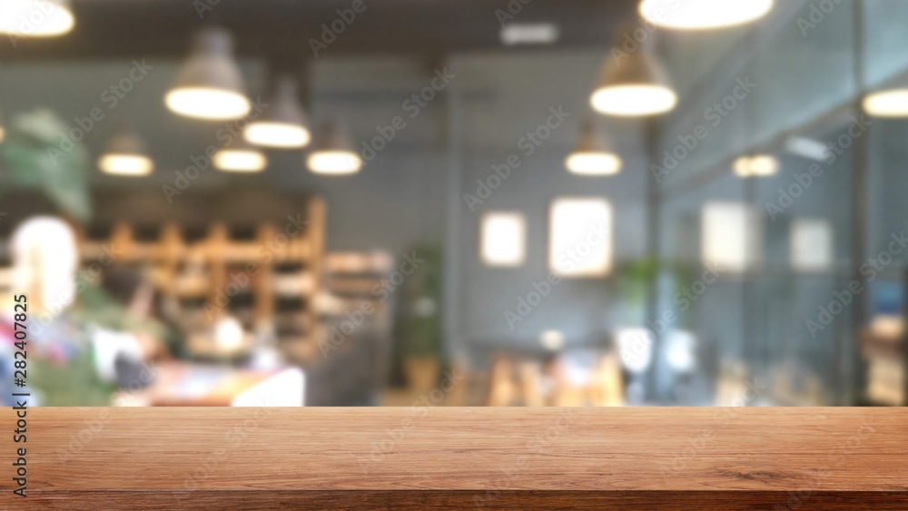 Empty wood table top and blurred bokeh cafe and coffee shop interior ...